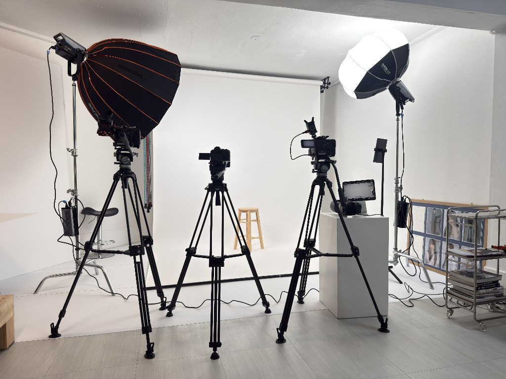 Professional camera and lighting setup on white backdrop in TEAM CHAELOG studio